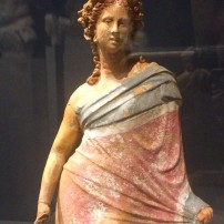 Tanagra-style figurine of a coquettish woman